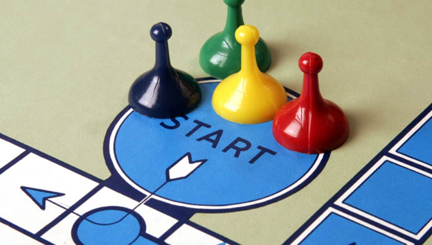 Game pieces sitting at the starting position on a game board