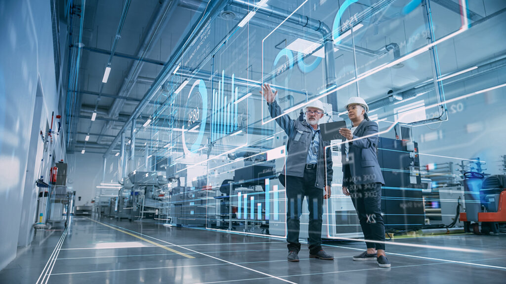 Man and Woman standing in a warehouse looking at hologram data points